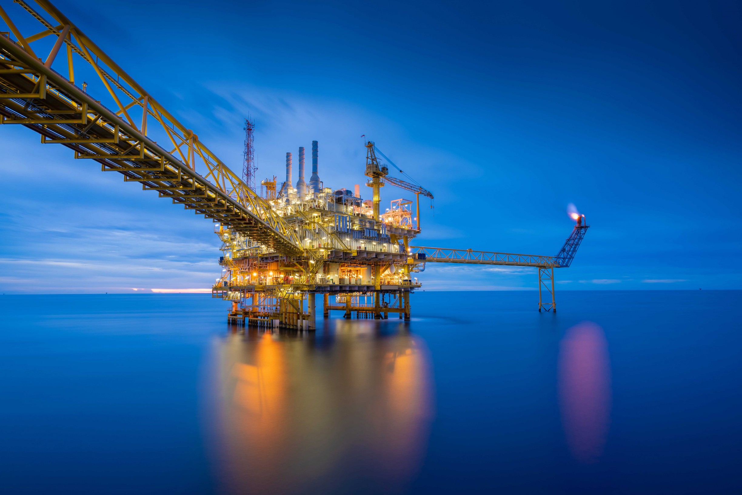 Offshore oil and gas processing platform at sunset